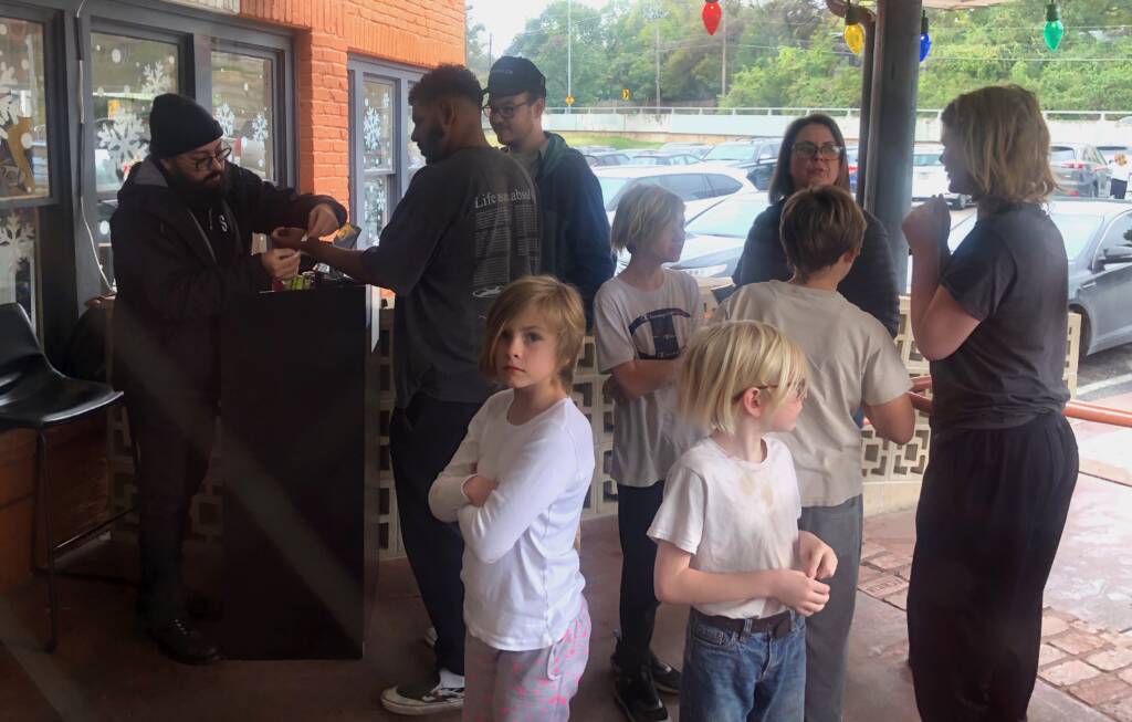 Parents and children waiting in line to enter Cidercade Austin